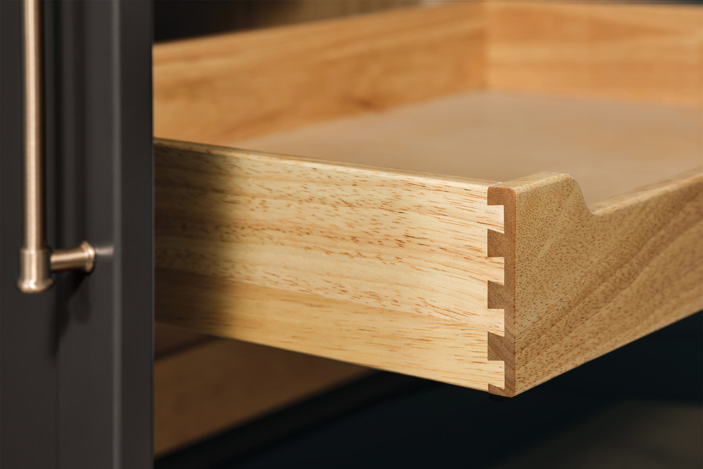 Close-up of a dovetailed drawer box and soft-close hardware