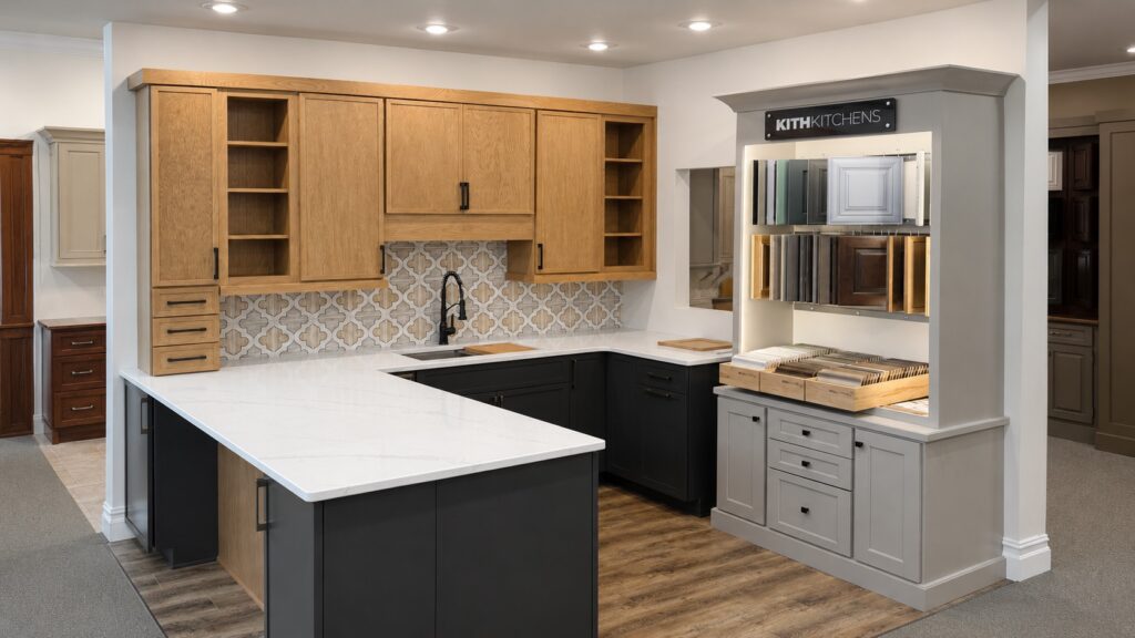 Kitchen display with wood upper cabinets, dark lower cabinets and a peninsula.