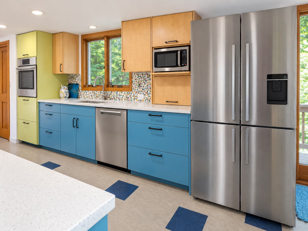 Blue kitchen cabinetry with a green oven tower, wood upper cabinets and stainless steel refrigerator.